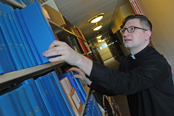 Deacon Cole Webster studies in the Christ the King Library as he prepares for his ordination at St. Joseph Catherdral on June 3. (Dan Cappellazzo/Staff Photographer)